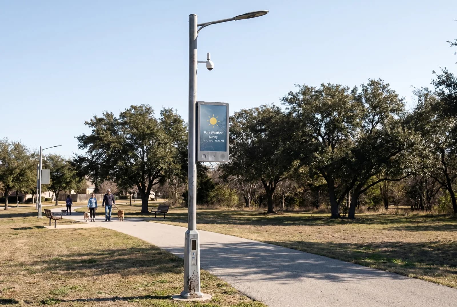 Smart pole deployed along a park pathway with LED information display and surveillance camera