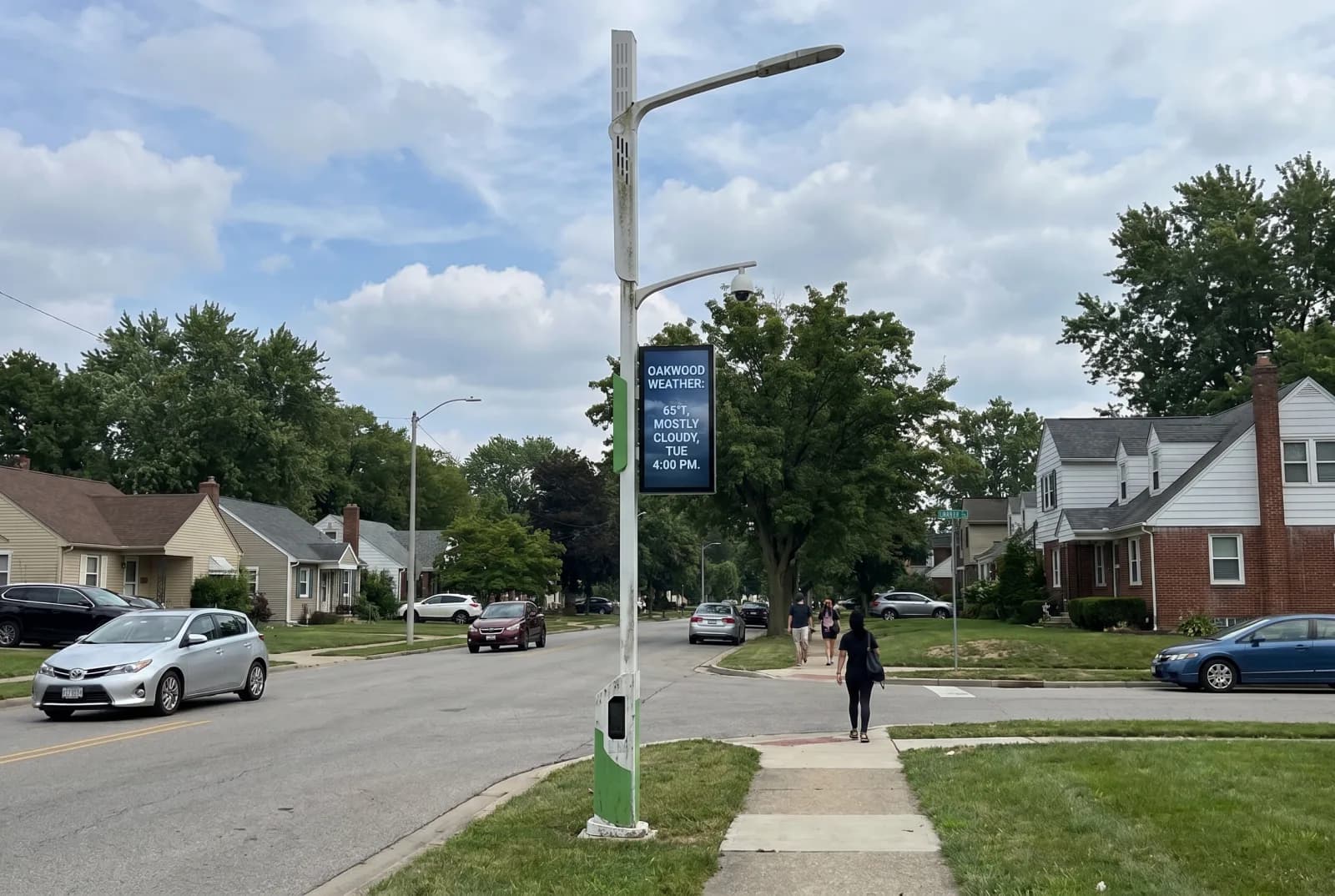 Smart pole with weather display on a residential street